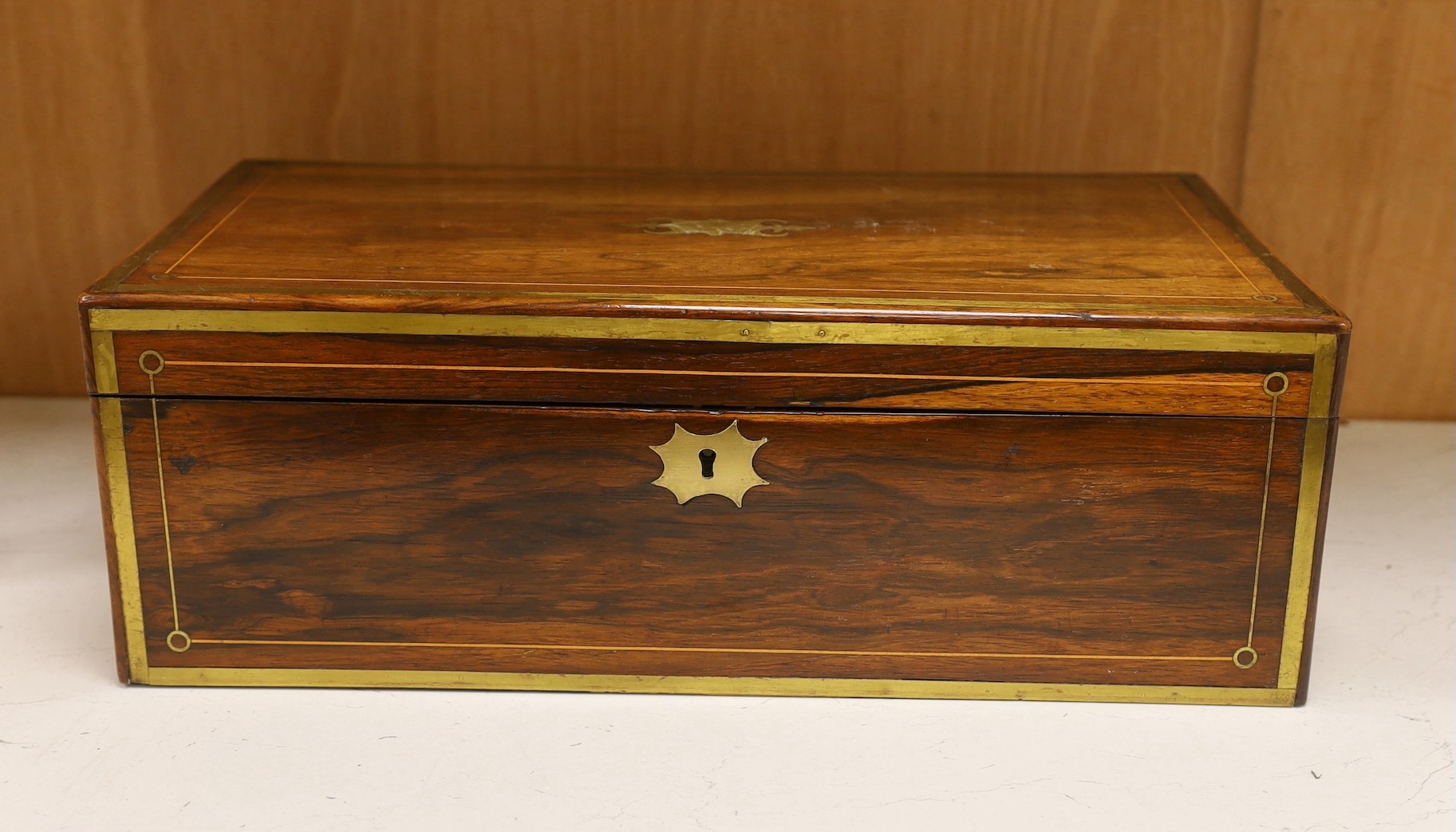 A Regency brass inlaid rosewood writing slope, 51 cms wide x 17 cms high.